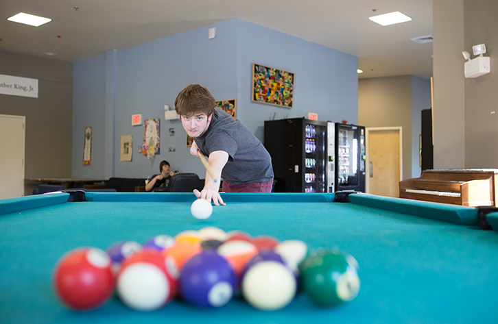 A student plays pool.