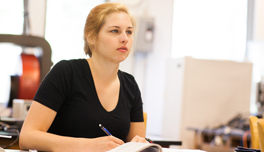 A female student listens attentively during class.