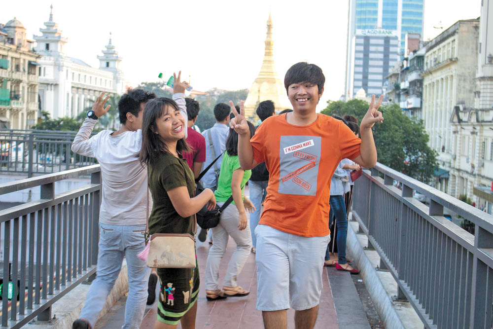 Students pose in front of Yangon’s Sule Pagoda