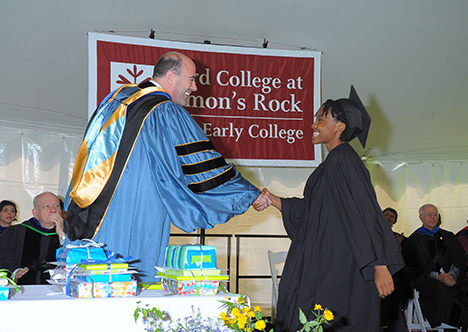 Provost Laipson shaking hands with female graduate