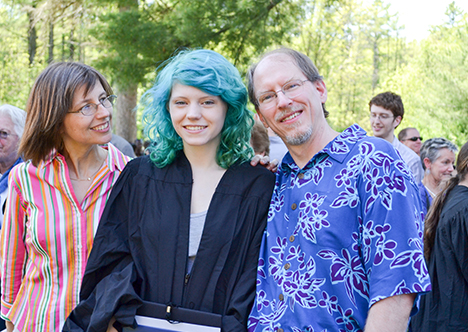 Student with parents at graduation